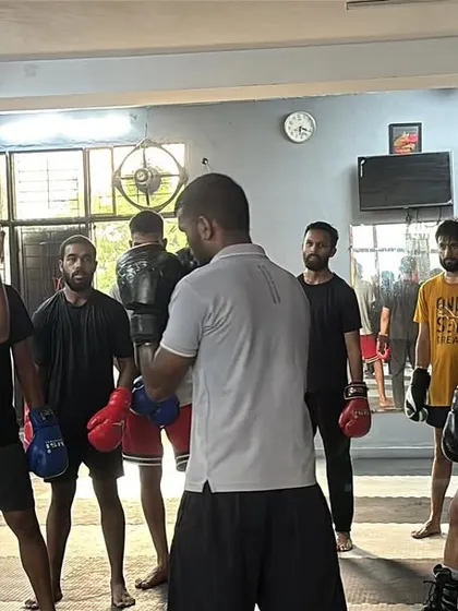 Sharpening the fundamentals with the group. I am demonstrating a defensive posture while students observe, ready to practice. This focus on technical detail is central to our training philosophy.