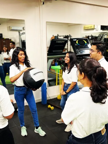 Dr. Chandana demonstrates an exercise to her colleagues. Her dedication to her work and personal fitness sets a great example.