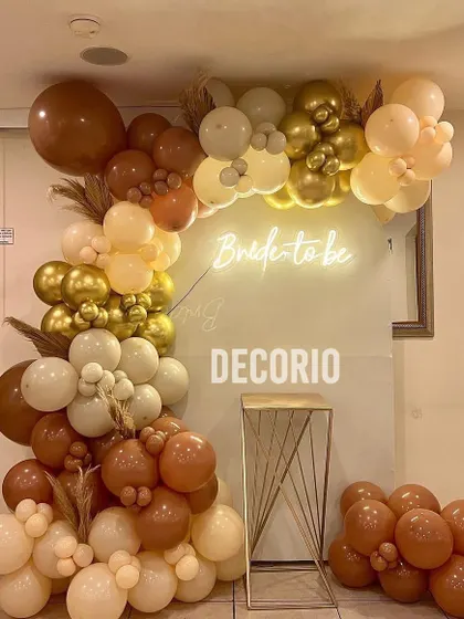 A closer view of the neutral-toned boho bachelorette setup. This style is perfect for an understated and elegant celebration, using a mix of balloon sizes and textures to create a visually interesting organic arch.