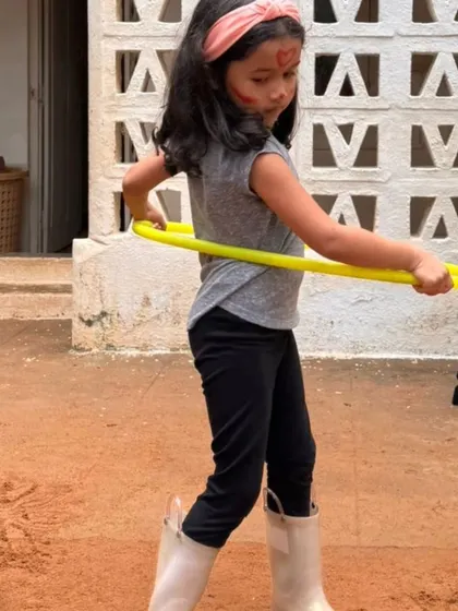 A child masters the hula hoop during our Children's Day carnival. Play is not just fun; it's how children develop coordination, perseverance, and confidence.