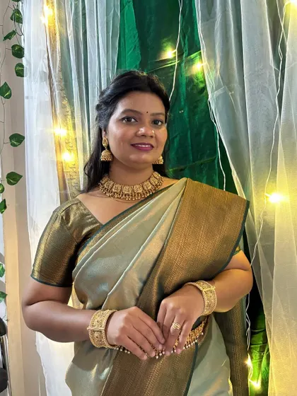 A simple, elegant pose showing the complete temple jewellery set. The choker sits perfectly at the neck, complemented by the matching jhumka earrings.