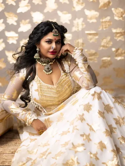 A regal pose that showcases the entire ensemble. This style is perfect for a sangeet night or a themed wedding event.