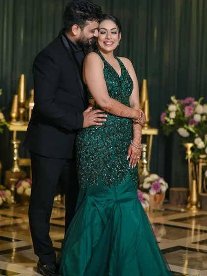 A classic, smiling portrait from their cocktail party. The couple looks radiant and happy, surrounded by beautiful decor, perfectly summarizing the joy of the evening.