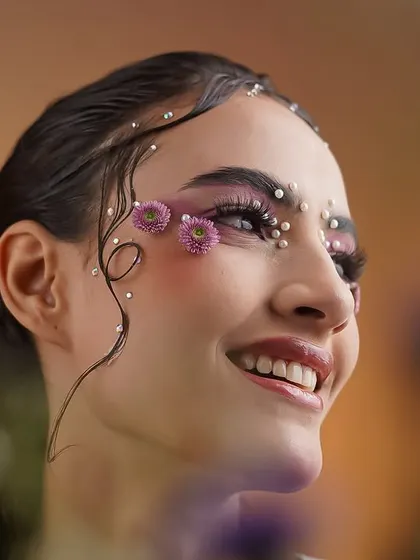 A happy and smiling shot from the creative makeup series. It shows that even highly artistic concepts can feel joyful and light.