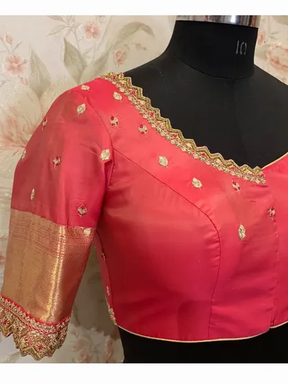 A side view of the red blouse, highlighting the beautiful zari border of the Kanjeevaram silk used for the sleeves.