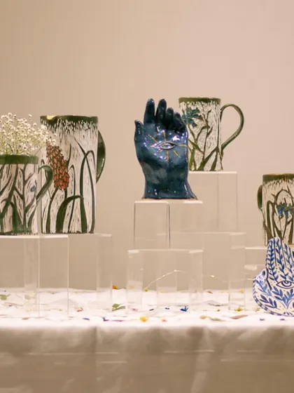 A collection of handcrafted pottery on display at a pop-up event. We love taking our students' work on the road!