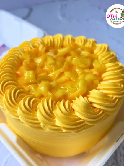 A close-up of our delicious mango bento cake. We use real Alphonso mango puree to ensure every bite is packed with authentic, tropical flavor.