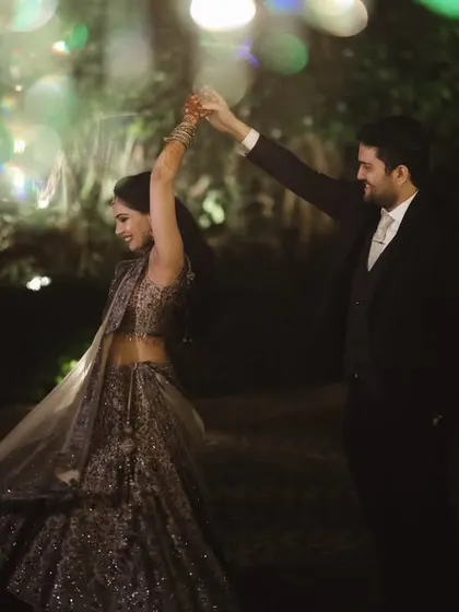 A couple twirling on the dance floor, framed by colorful, blurry lights. This shot captures the magic and romance of their first dance as husband and wife.