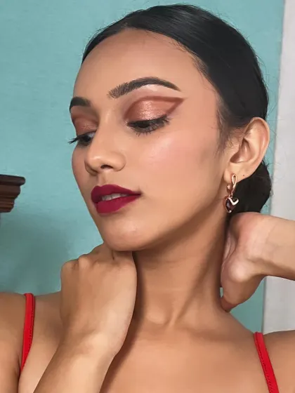 This angle showcases the full effect of the graphic liner and bold lip combination. It's a look that is both elegant and daring.