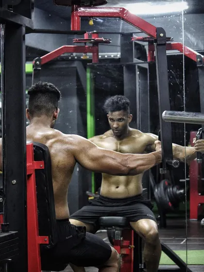 Focus. A shot of me on the pec deck fly machine, concentrating on isolating the chest muscles.