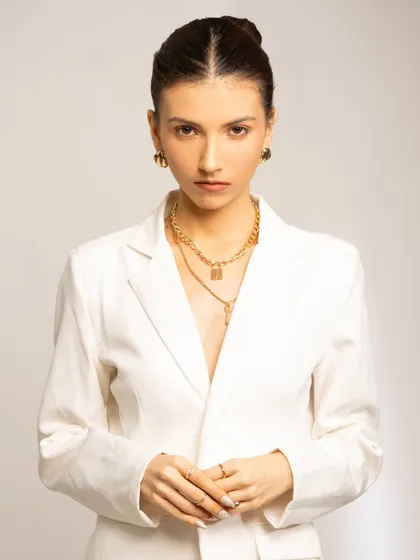 A clean, professional look perfect for a corporate or commercial setting. The makeup is minimal and fresh, with neatly pulled-back hair, conveying a sense of focus and power.