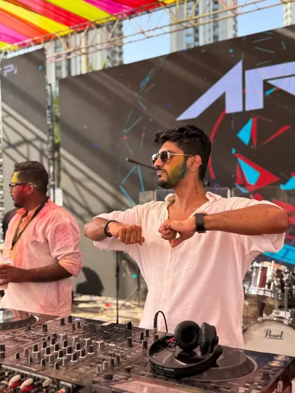 Dancing along with the beat at the Holi festival. I'm not just playing the music; I'm feeling it and moving with the crowd.