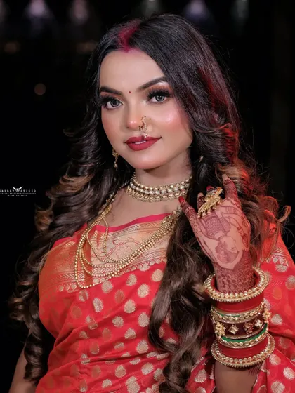 A classic portrait pose, with the model's hand gently resting on her cheek. Her confident expression and the rich details of her saree create a timeless image.