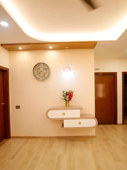 Simplicity and elegance define this entryway. A floating console with curved drawers and subtle wall lighting creates a welcoming first impression without cluttering the space.