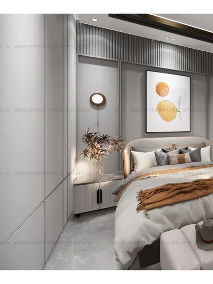 A bedroom in Vishal Enclave with a grey-paneled wall and warm orange accents, creating a cozy and contemporary space.