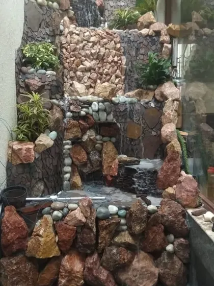 Even a narrow space can accommodate a stunning water feature. I designed and built this vertical stone waterfall to fit perfectly into a wall niche, bringing the sound of water into a compact area.