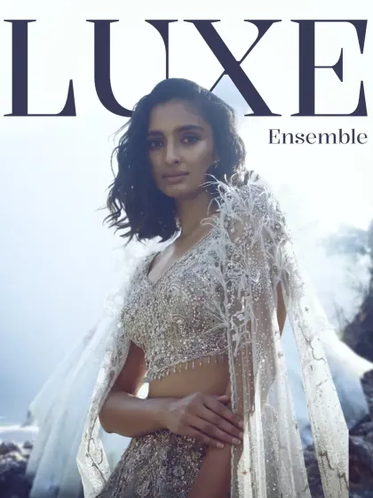 Luxe is in the layers. This image, featuring a stunning embellished lehenga with a feathered cape, introduces our collection of luxe ensembles for the season ahead.