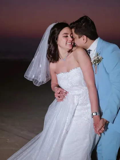 A tender moment as the sun sets over the ocean. This intimate portrait captures the romance of a destination Catholic wedding.