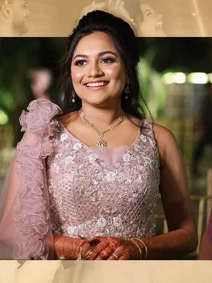A candid shot of the bride enjoying her reception. Her lavender-themed outfit and radiant smile light up the event.
