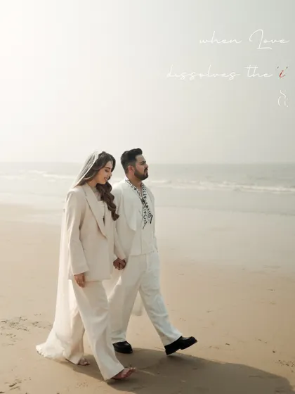 "when love dissolves the 'i'". This poetic phrase perfectly describes the feeling of this beachside portrait. The couple walks as one, their figures blending into the soft, hazy light of the sea.