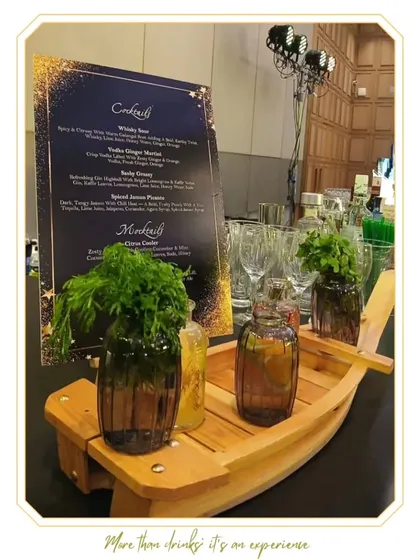 A detailed view of our bar setup, featuring a custom-printed cocktail menu and unique, boat-shaped garnish holders. These small touches contribute to a cohesive and thoughtfully designed experience.