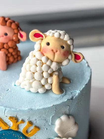 A close-up on the super cute, handmade fondant sheep toppers. I make each one by hand, giving them their own personality.