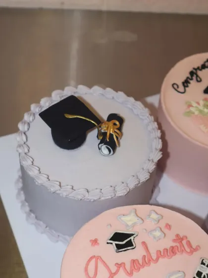 A close-up of our graduation-themed bento cake, featuring a meticulously crafted fondant graduation cap and diploma scroll. The details make all the difference in celebrating such a big milestone.