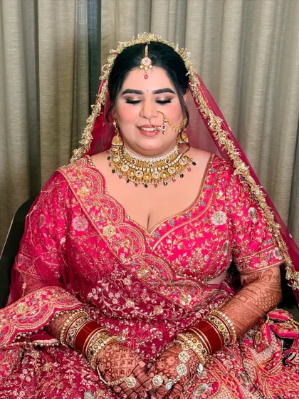 A moment of peace before the ceremony. The soft-focus eye makeup and perfectly blended base create a serene and beautiful bridal look.