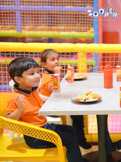 Two young friends take a break to enjoy their snacks. The cafe is a great place to sit back and recharge.