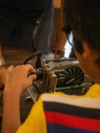 A close-up of a student connecting a port on the graphics card. We ensure every child gets a chance to handle the components and build confidence.
