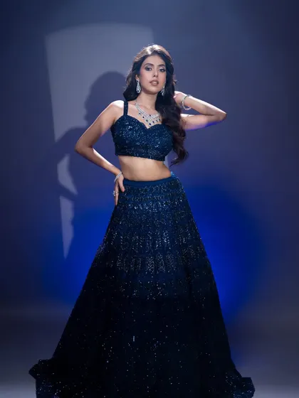 A full-length view of this glamorous evening look. The makeup is designed to stand out and complement the sparkle of the outfit.
