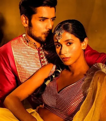 A moody and artistic shot for the Nayantaara campaign. The makeup is warm and bronzed, with a traditional headpiece, creating a regal and timeless look that fits the dramatic lighting.