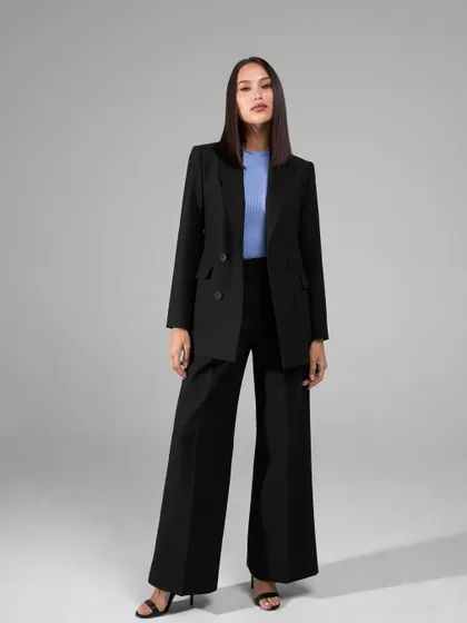 A classic black power suit is a wardrobe essential. This one features a double-breasted blazer and dramatic wide-leg trousers for a timeless and commanding look.