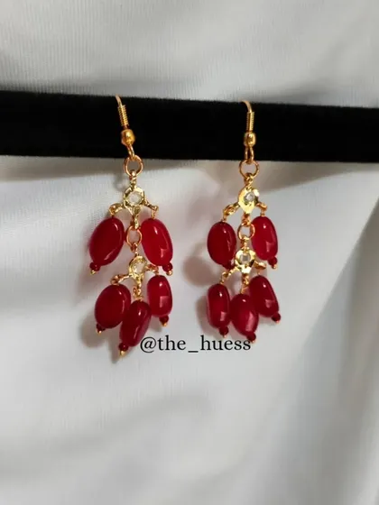 A close-up of the Hyderabadi Jadau Reshmi earrings in a vibrant red. These simple yet elegant danglers are one of my most requested items for Mehendi and Haldi return gifts.