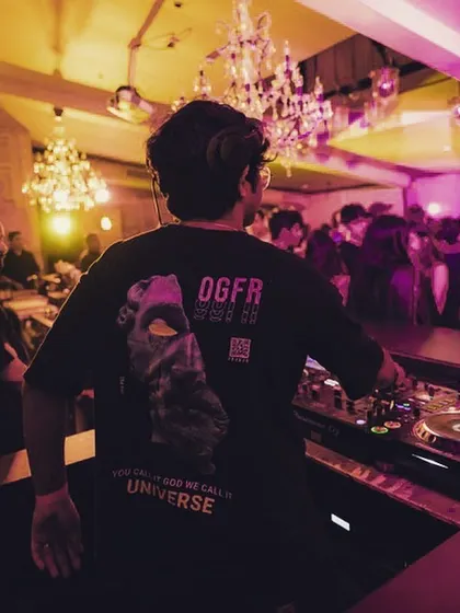 A shot from behind, showing off my shirt and the elegant chandeliers of the venue. Even in a high-energy party, the atmosphere matters.