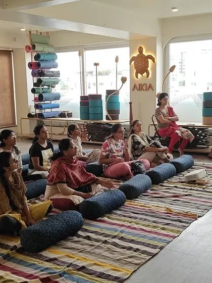 Participants in our Menopause Workshop listen intently, learning how yoga and mindfulness can help manage symptoms and promote hormonal balance.