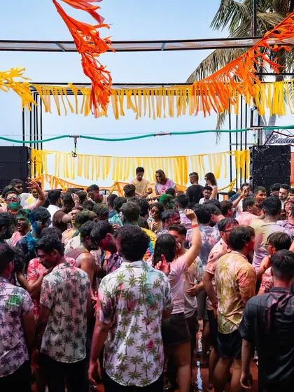 A packed dance floor at our Goa Holi event. The setup includes themed decor with colorful streamers, creating a festive and immersive environment for all attendees.