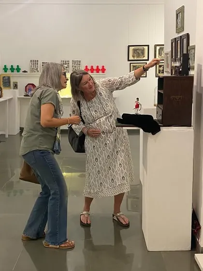 Artist Clare Arni in conversation with visitors at her exhibition.