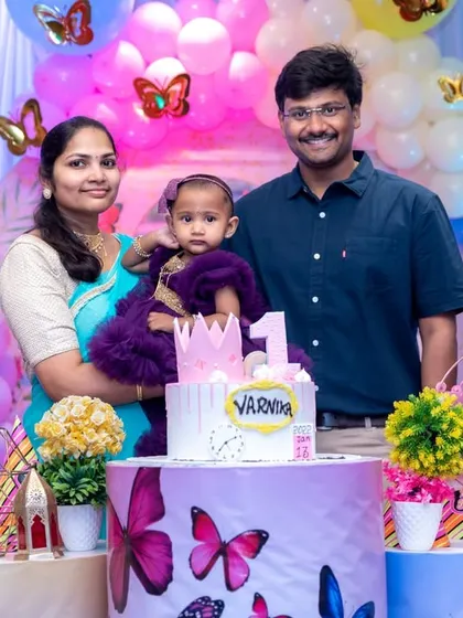 A lovely family portrait with the birthday girl and her first birthday cake. We compose our shots to include the cake, the decor, and the happy family all in one frame.