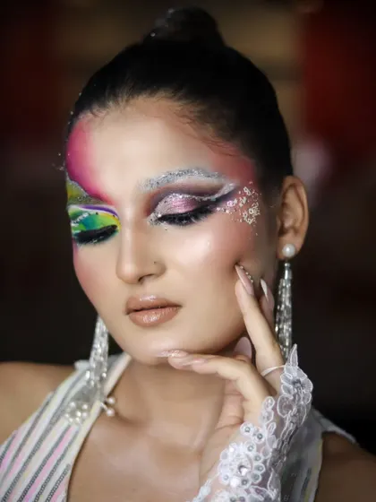 A close-up on the eye makeup, showing the layers of color and the delicate application of glitter.