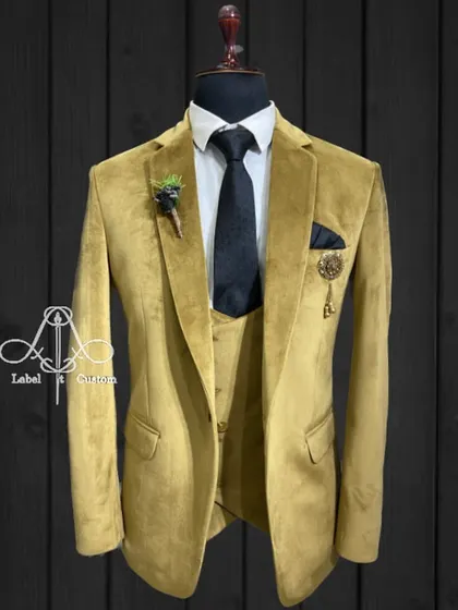 A luxurious mustard yellow velvet suit. The texture of the velvet adds depth and richness, making it an excellent choice for a festive occasion or a winter event.