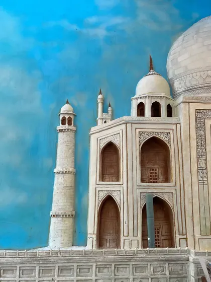 A detailed section of a 3D fiber mural depicting the Taj Mahal. This shot focuses on the intricate architectural details of the main structure and minarets against a bright blue sky.