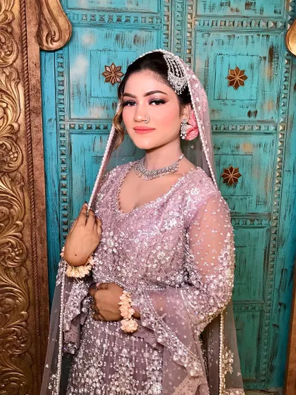 A beautiful portrait of my bride in her pastel purple and silver outfit. The peachy tones in the makeup add warmth and a soft, dreamy glow.