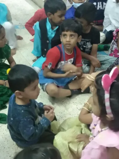 A candid moment of interaction between children during a festival. These events are important opportunities for social learning and practicing grace and courtesy.
