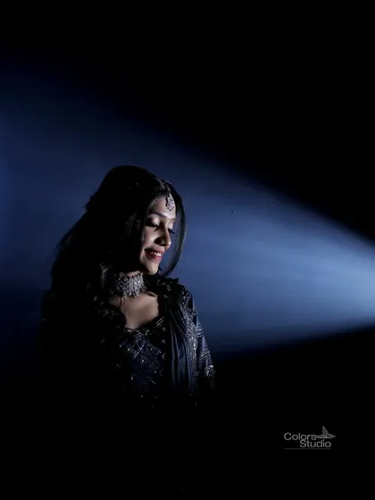 A dramatic, low-key portrait of the bride, using a single spotlight to create a moody and artistic feel.
