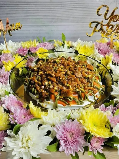 This decadent mango pistachio tres leches, crowned with pistachio praline and framed by elegant blooms, is a grand gesture for Mother's Day. The custom toppers add a personal touch to show her she's precious.