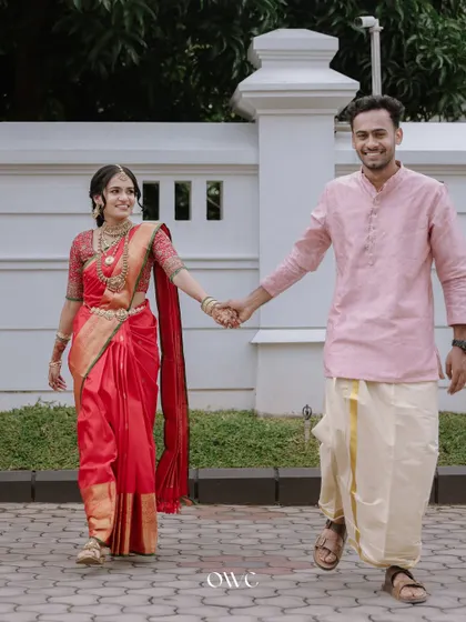 A happy couple walking hand-in-hand after their engagement or wedding ceremony.