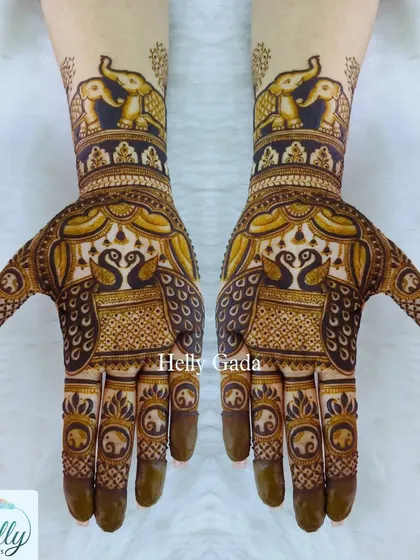 A regal design featuring majestic elephants on the forearm and graceful peacocks on the palm. This combination of powerful symbols creates a rich narrative of strength and beauty.
