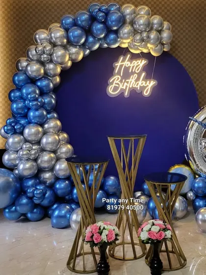 A closer view of the 6-month birthday setup, highlighting the chrome balloons and neon sign.