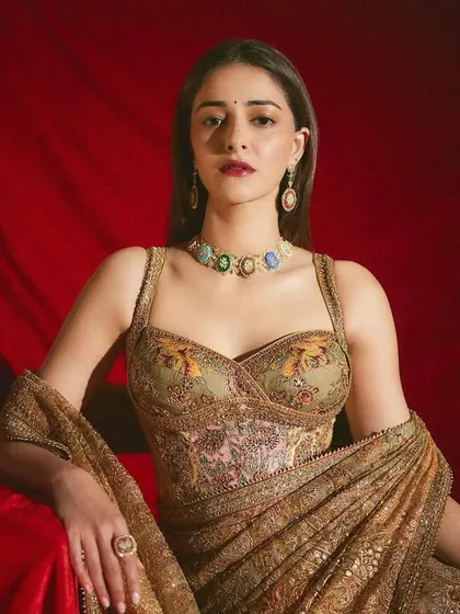 A stunning portrait of Ananya Panday wearing the full Navratna micromosaic set. The choker and earrings feature a variety of gemstones, each telling a unique story through intricate art.
